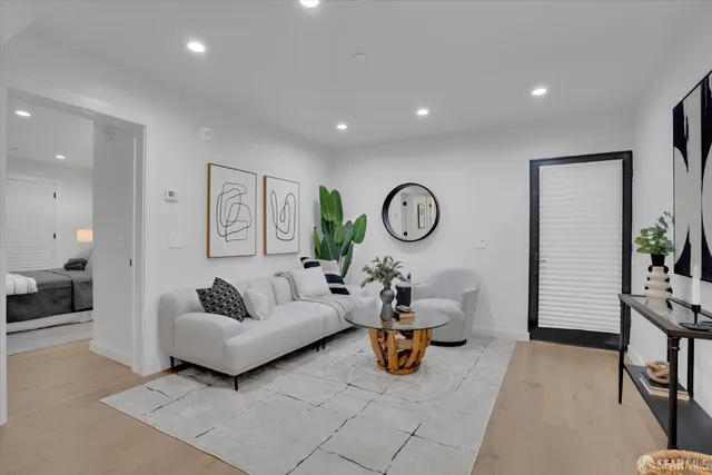 a living room with furniture and a mirror