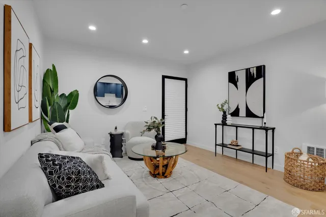 a living room with furniture and a mirror