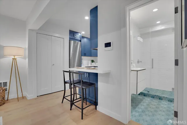 a view of kitchen with furniture and a refrigerator