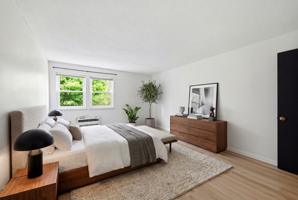 80 Damon Road, Unit 2303 Northampton, MA 01060 - Photo 18 of 23 a bedroom with a bed and wooden floor