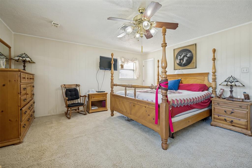 117 County Road Decatur, TX 76234 - Photo 22 of 40 Plush carpeting, paneled walls, ceiling fan with integrated lighting, and a window with blinds