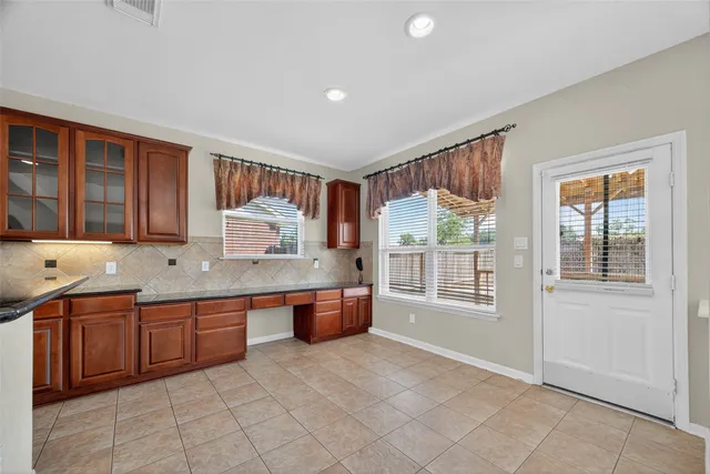 a kitchen with stainless steel appliances granite countertop a stove sink and cabinets
