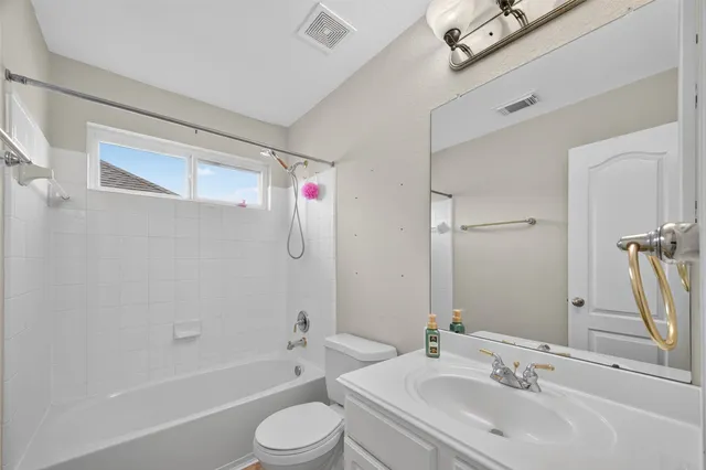 a bathroom with a sink mirror toilet and bathtub