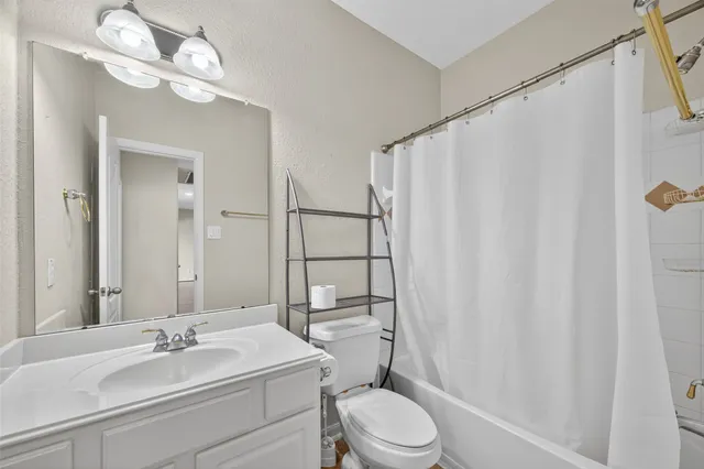 a bathroom with a sink vanity mirror and toilet