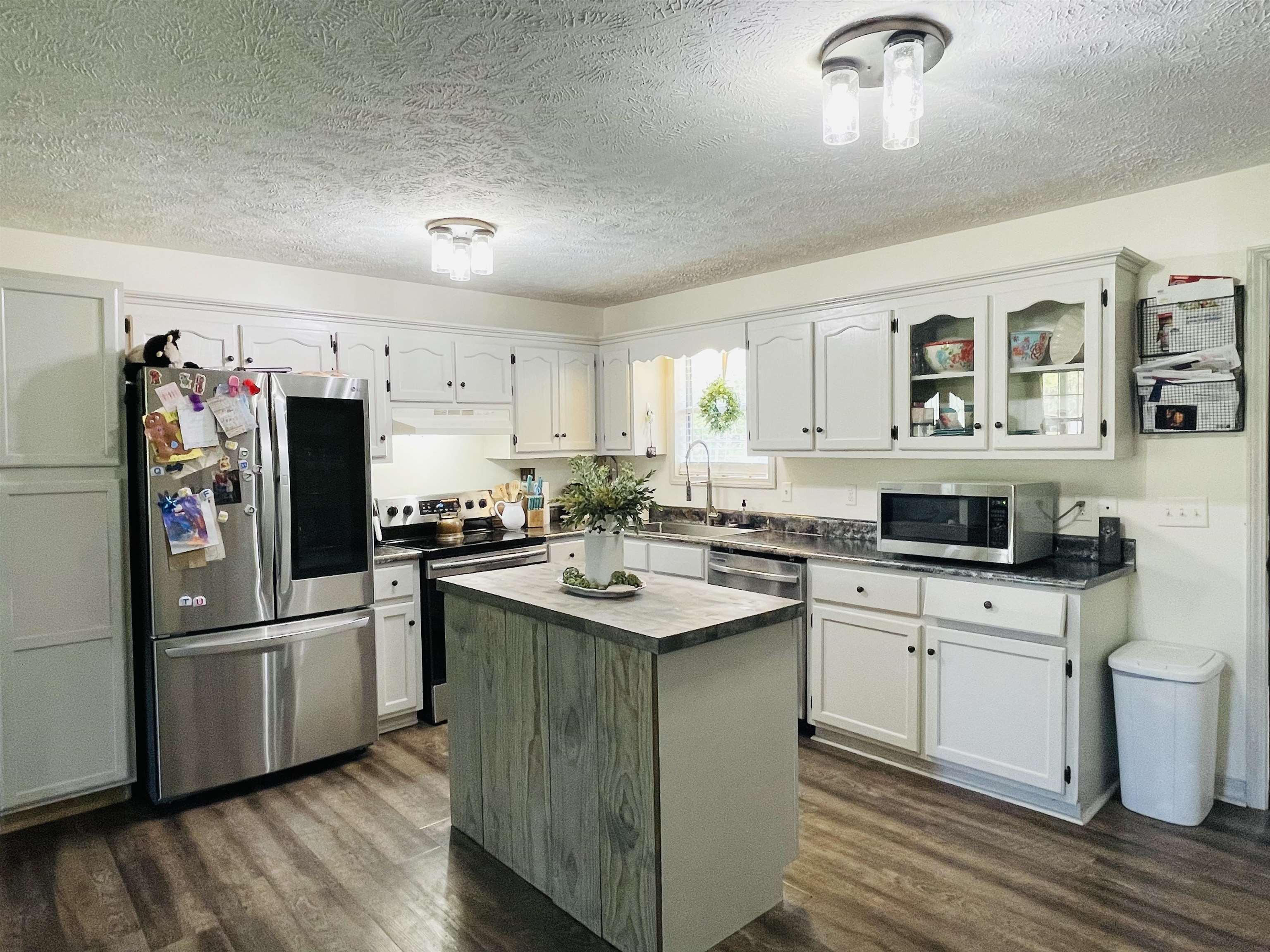 207 Chris Lane Ramer, TN 38367 - Photo 4 of 15 a kitchen with stainless steel appliances granite countertop a sink stove and refrigerator