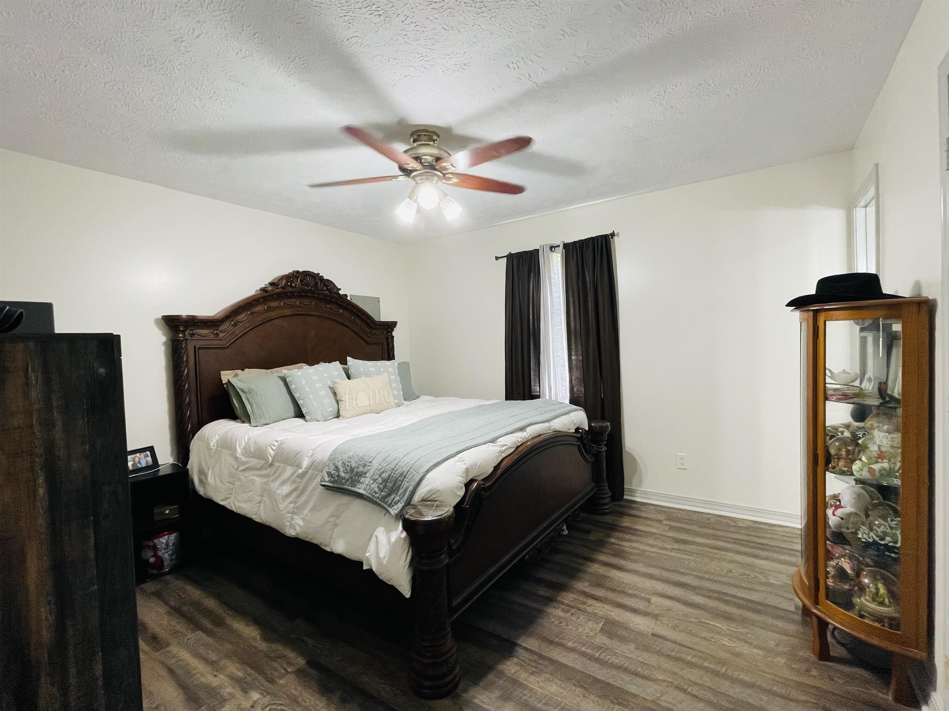 207 Chris Lane Ramer, TN 38367 - Photo 8 of 15 a bedroom with a bed and a chandelier