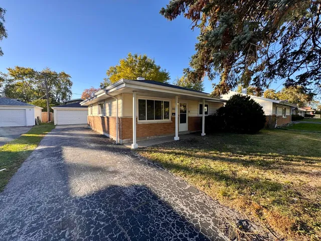 a view of a house with backyard and sitting area