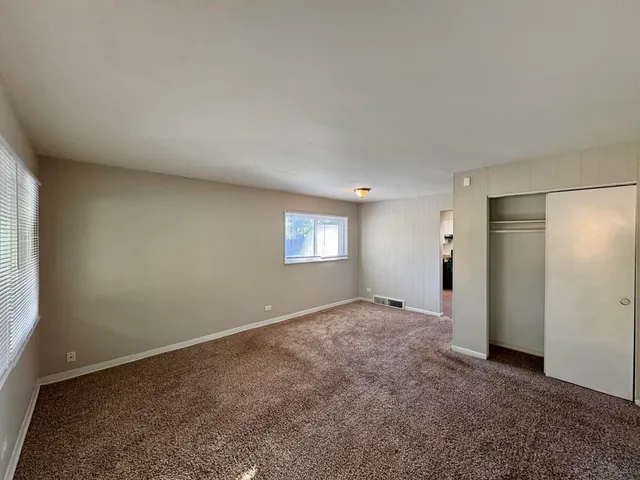 an empty room with a window and a projector