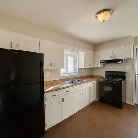 a kitchen with a sink stove and cabinets