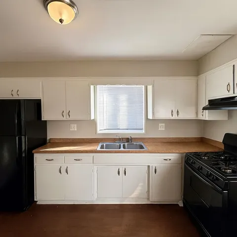 a kitchen that has a sink and a stove