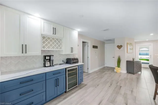a view of a kitchen with cabinets stainless steel appliances and wooden floor