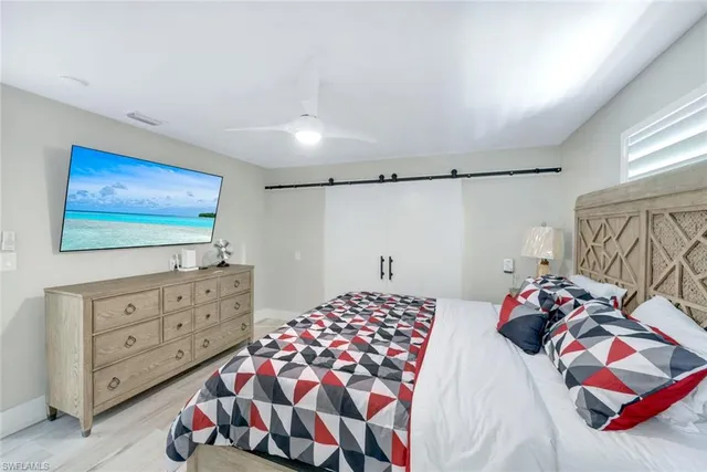 a bedroom with a bed and a dresser in it