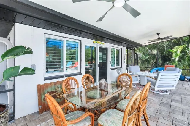 a view of a patio with couches chairs and potted plants