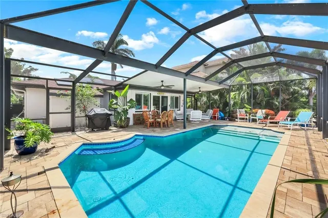 a view of swimming pool with outdoor seating