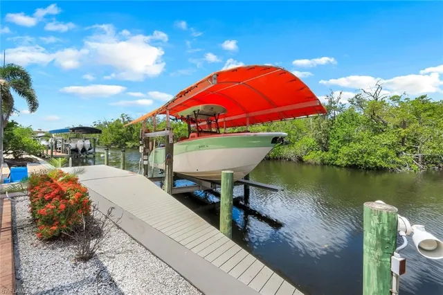 a view of a lake with a table and chairs