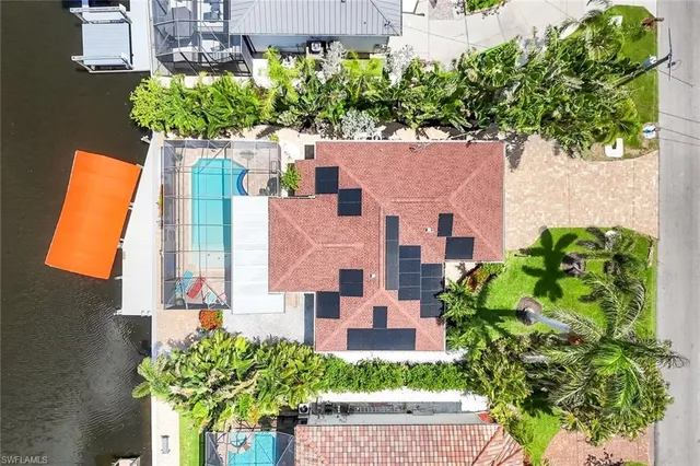 an aerial view of a house with a yard and garden
