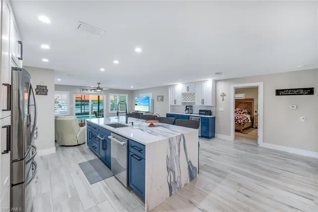 a kitchen with a sink appliances and cabinets