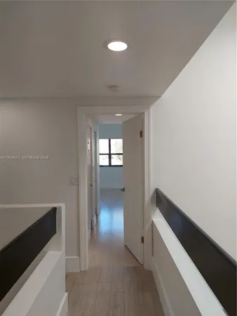 a view of hallway with wooden floor