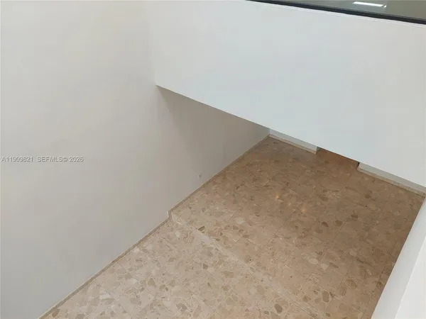 a view of a hallway with wooden shelves