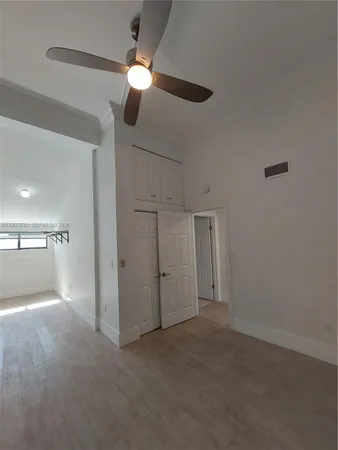 a view of an empty room with a floor to ceiling window