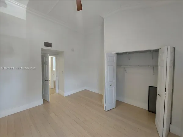 a view of walk in closet with empty racks