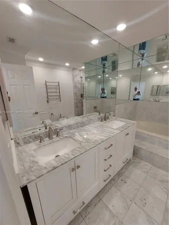 a bathroom with double sink and a mirror
