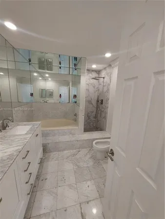 a bathroom with a granite countertop sink mirror and shower