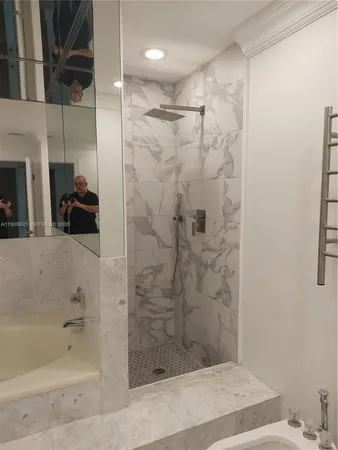 a bathroom with a shower and a sink