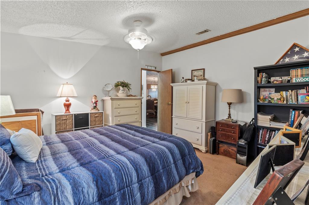 83 Eagle Circle Ellenton, FL 34222 - Photo 31 of 60 a bed room with a bed and a book shelf