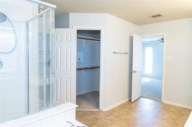a view of a room with wooden floor and entryway