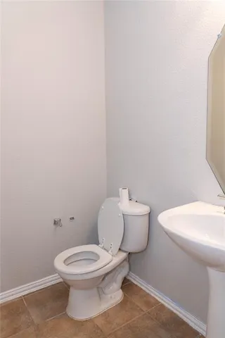a white toilet sitting next to a white sink