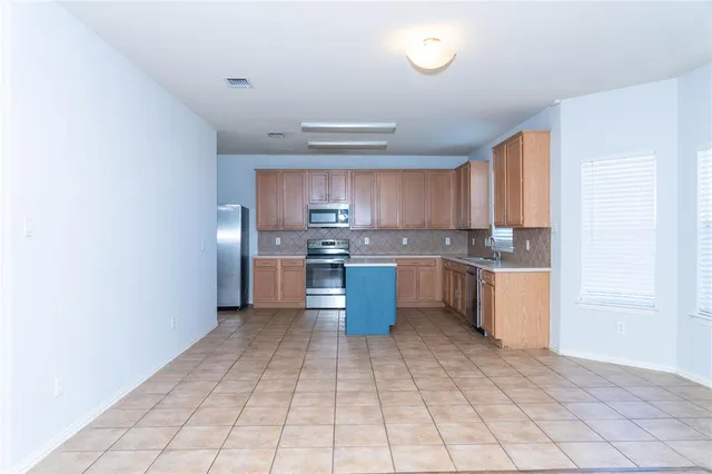 a kitchen with a cabinets and window