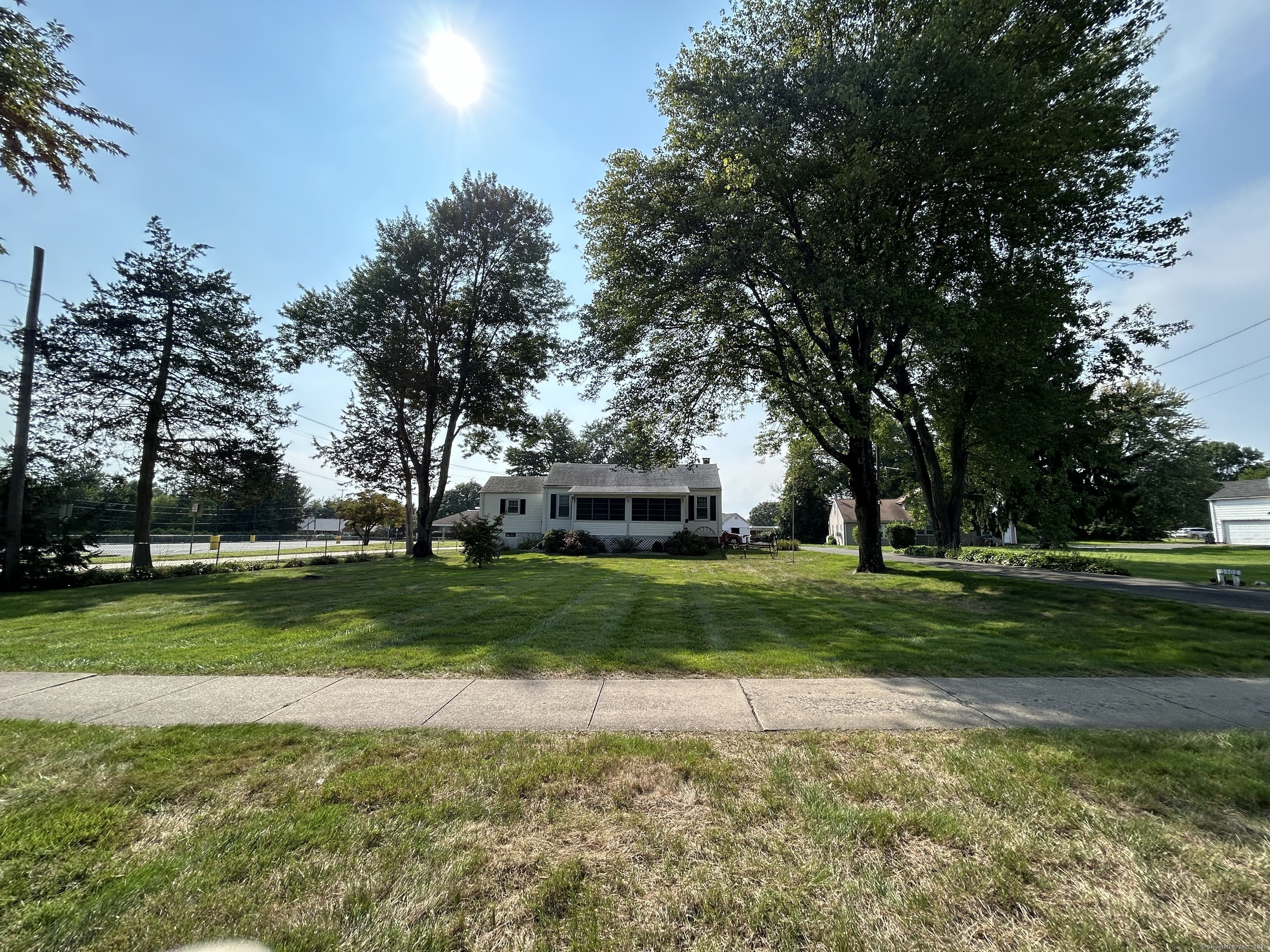 a front view of a house with a yard and trees