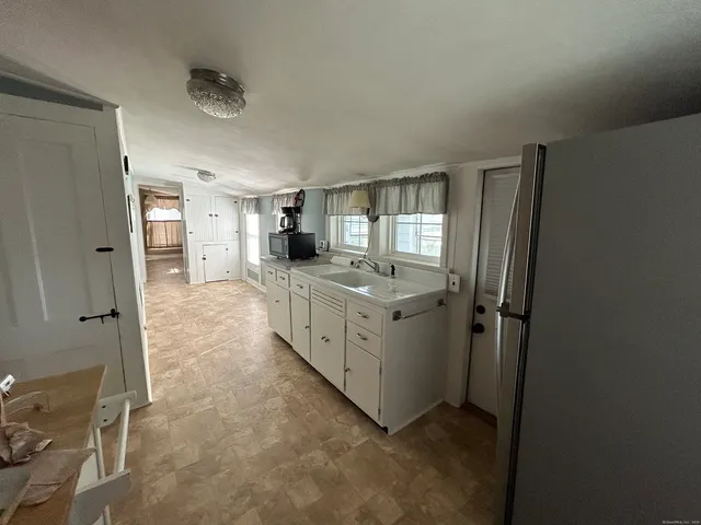 a kitchen with cabinets and window