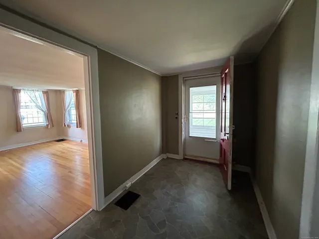 an empty room with windows and closet