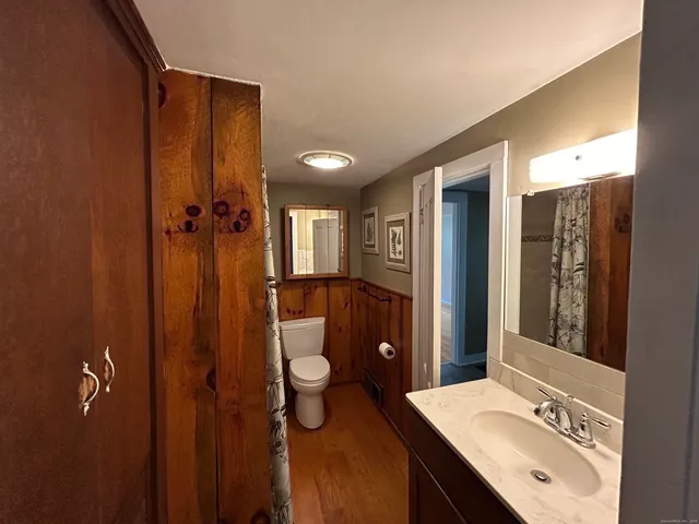 a bathroom with a sink double vanity granite tub shower and mirror