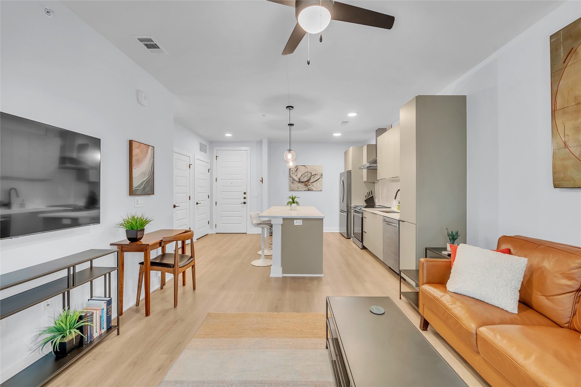2500 Longview Street, Unit 217 Austin, TX 78705 - Photo 9 of 35 Living area with light wood-type flooring, ceiling fan, and recessed lighting