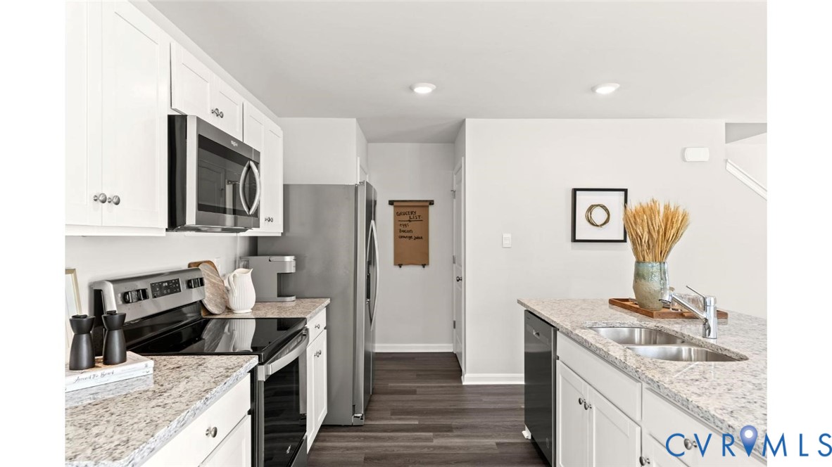 7731 Arbor Marsh Terrace New Kent, VA 23124 - Photo 12 of 37 a kitchen with stainless steel appliances granite countertop a sink stove and refrigerator