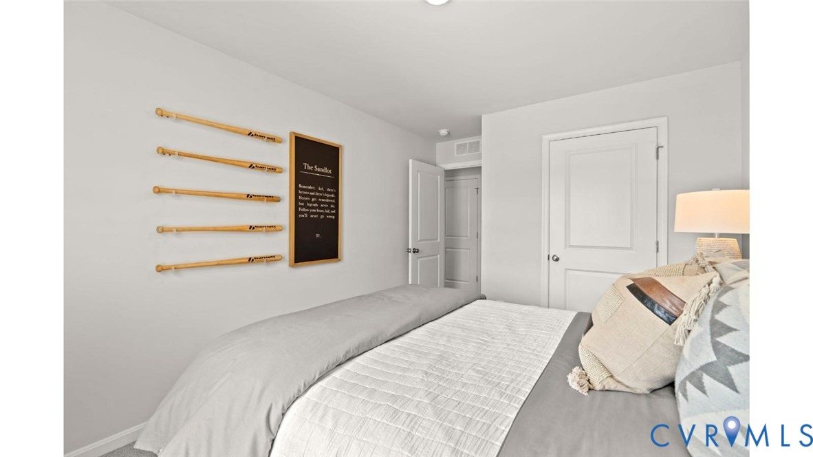 7731 Arbor Marsh Terrace New Kent, VA 23124 - Photo 15 of 37 a bedroom with a bed and a lamp