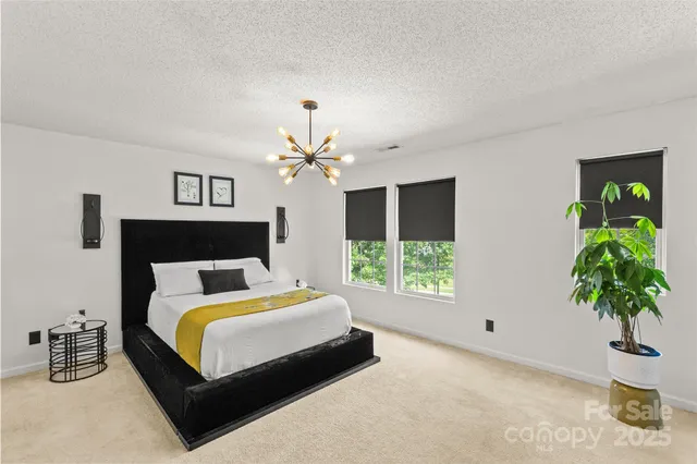 a bedroom with a bed and a potted plant