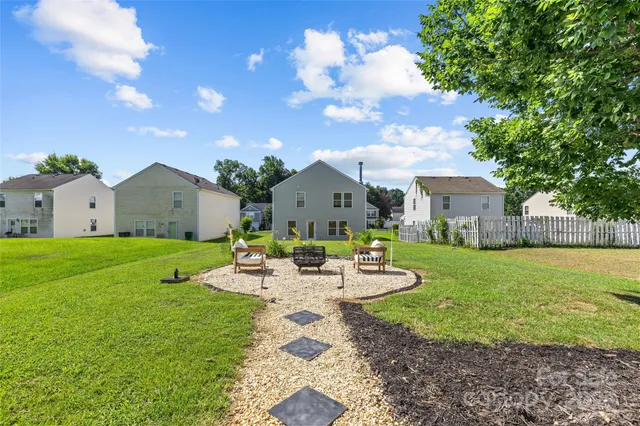 a view of a house with backyard and sitting area
