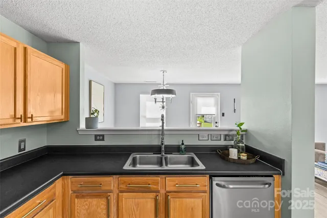 a kitchen with granite countertop a sink and a window