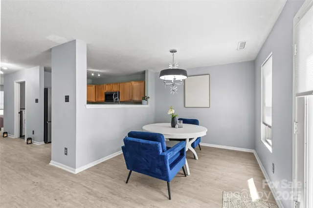 a view of a kitchen area with furniture window and wooden floor