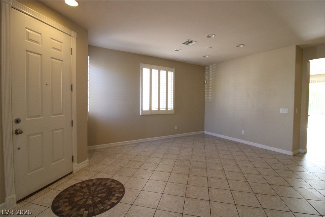 754 Rise Canyon Drive Henderson, NV 89052 - Photo 5 of 34 A well-lit entry with tiled flooring welcomes guests into this home.