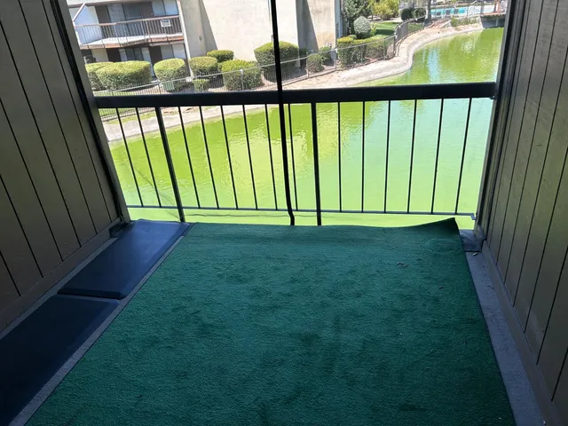 a view of swimming pool with outdoor seating and lake view