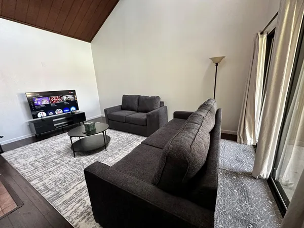 a room with a bed and wooden floor