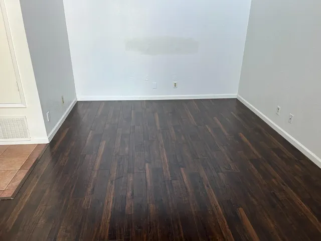 a view of a room with wooden floor