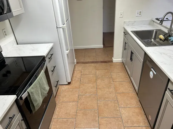 a kitchen with a sink a stove and refrigerator
