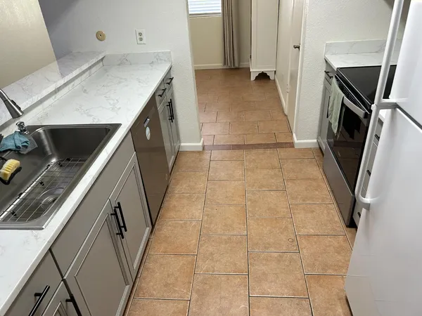 a stove top oven sitting inside of a kitchen