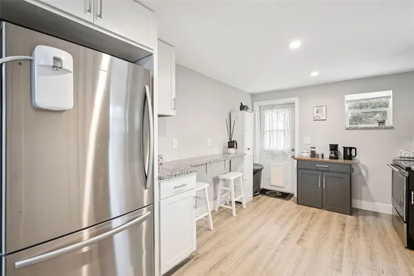 a kitchen with stainless steel appliances a refrigerator and a stove top oven